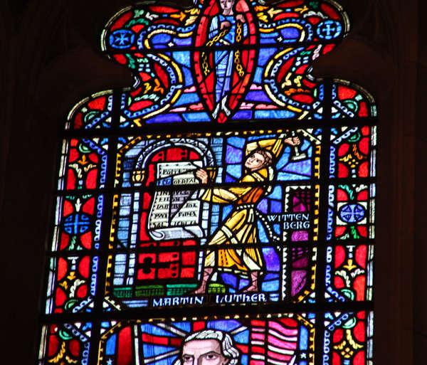 Detail of a church window. Martin Luther nails his 95 theses to the church door in Wittenberg.