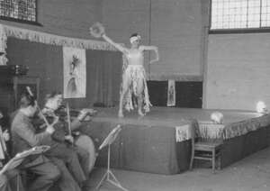 Photo of Andrea Bentschneider's great uncle Lothar Rex performing in front of other Wehrmacht soldiers as "Luna" - lightly clad in bra and turban.